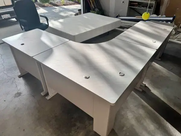 Office desks with L shape computer/printer assembly.