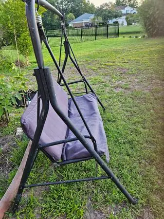 Backyard swing with cushioned seat and back.