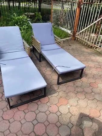 Pair of teak and bronze finished steel patio lounge chairs