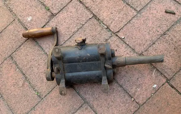 antique cast-iron cigar grinder is a hand-cranked tobacco shredder o