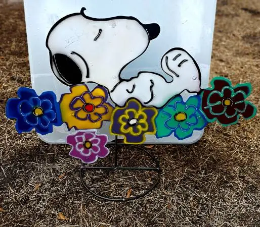 Yard Art Snoopy on top of a Bed of Flowers