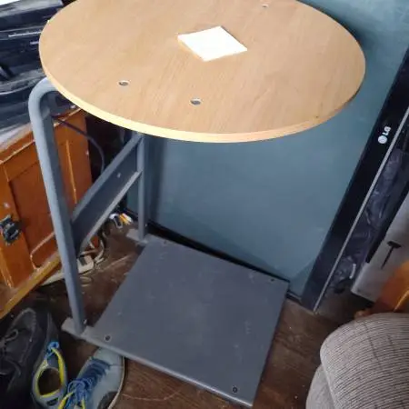 Table, wood circular top, metal frame on wheels, $10