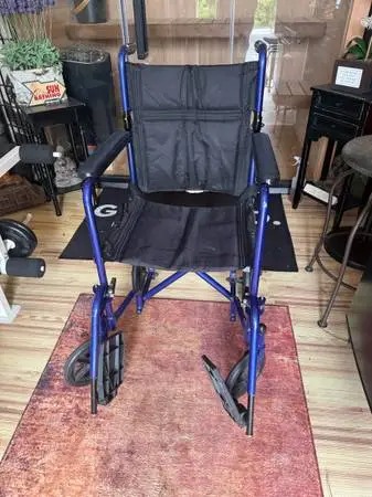 Blue transport wheelchair. Very lightweight and easy to fold up. Compact design