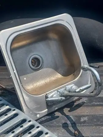 Small stainless steel sink with faucet