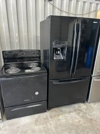 Black refrigerator and electric stove
