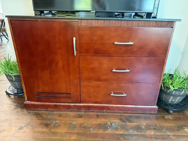 stand 60” long 24” deep 40 1/2” tall has 3 drawers and a cabinet area
