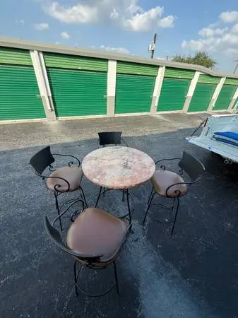 Wrought Iron, Marble Top Table With Four Swivel Bar Stools.