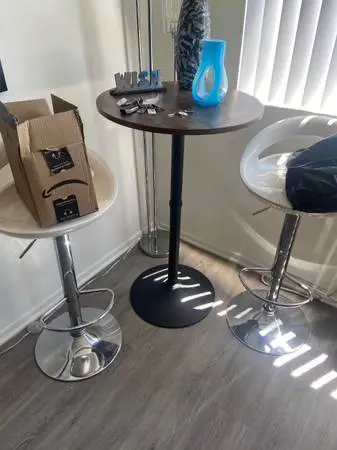 4 bar stools and a round table