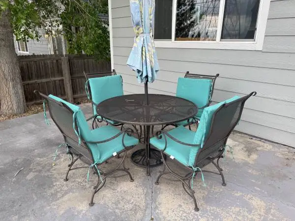 Wrought iron patio table  w/4 matching chairs for sale.