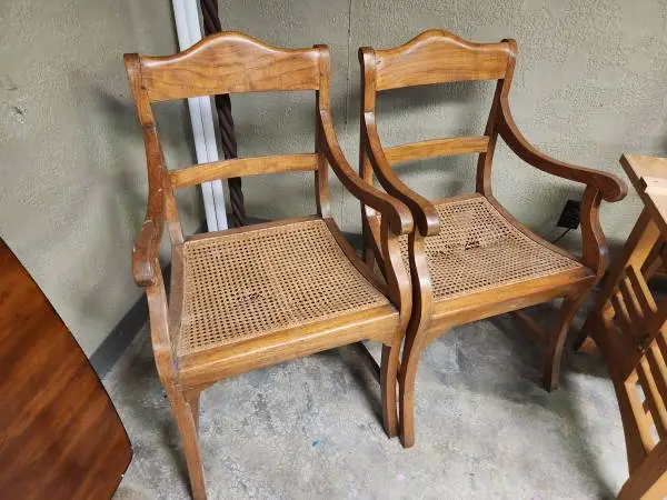 Two top quality solid wood cained arm chairs.