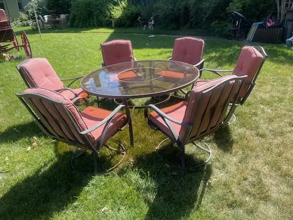 60” bronze finished round glass top patio table with six swivel chairs