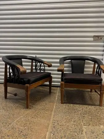 Pair of vintage walnut and vinyl horseshoe club chairs