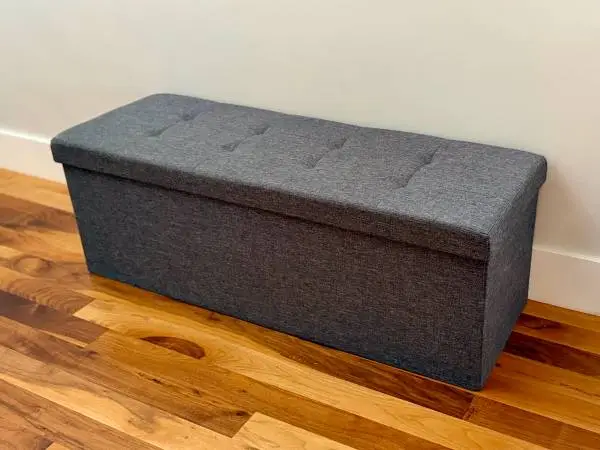 Dark gray tufted fabric ottoman with storage - like new!