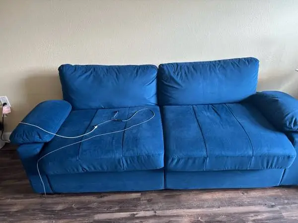 Nice blue couch with charging accessories