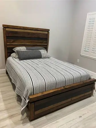 Solid wood Queen bed gently used. Still has tags. Couple of scuffs