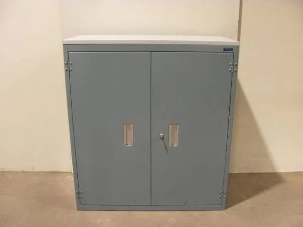 Corcraft blue green metal two door storage cabinet with 2 shelves