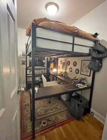 lofted full-size bed with desk