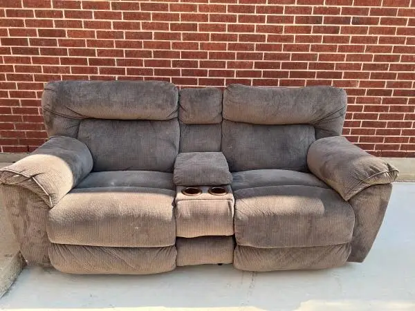 Upholstery is slightly damaged - light brown 2-recliner sofa
