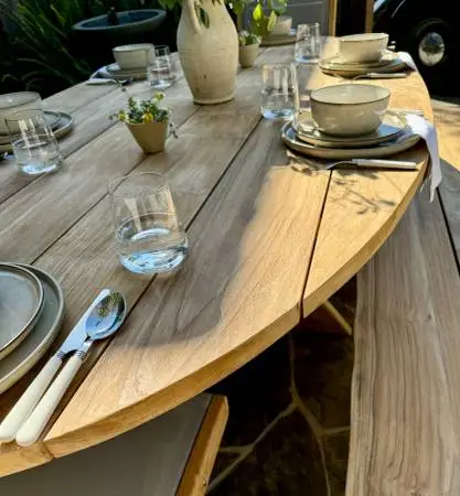 Elliptical solid teak outdoor tables and benches. Locally made