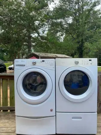 Stackable washer and dryer set on pedestal drawers