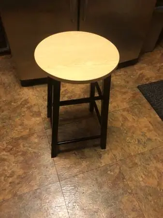 Black metal stool with wood laminate top