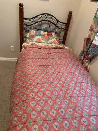 Twin bed including frame, mattress, sheets, Skirt, & bedspread