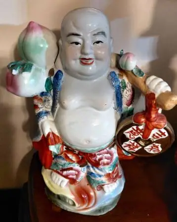Porcelain Buddha Carrying a Coin & Fruits on a Pole