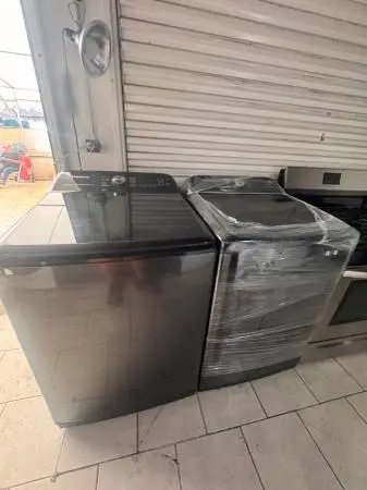 Samsung black jumbo 5.0 cu ft top load washer and gas dryer