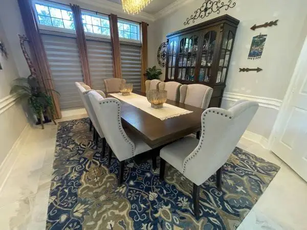 Dining room set with 8 chairs and a lighted buffet