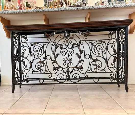 Ornate wrought iron console table.