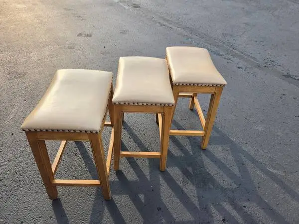 3 tan leather bar stools with zero scratches in perfect condition