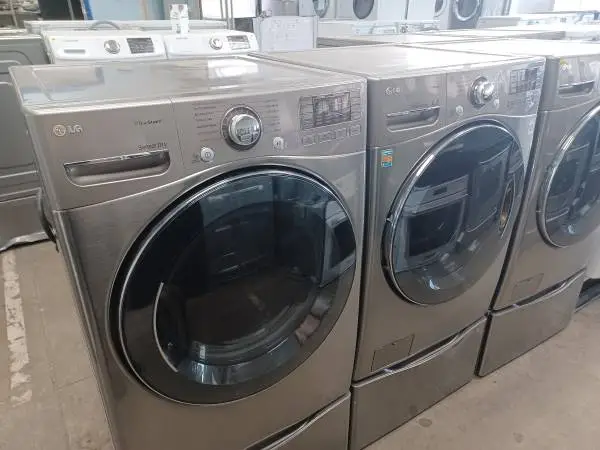 LG Grey Front Load Washer/Electric Dryer Set On Pedestals