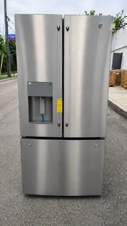 Brand new 33 in GE french door refrigerator with water dispenser on the door