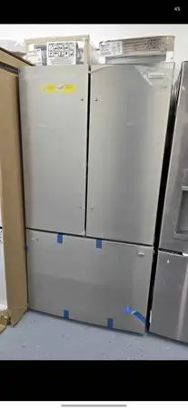 Brand new French door refrigerator with water dispenser inside and ice maker