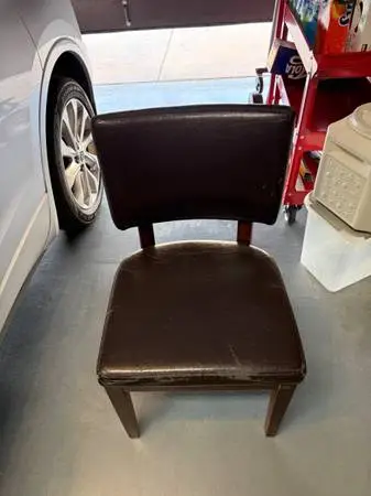 2 wood frame chairs with brown pleather upholstery