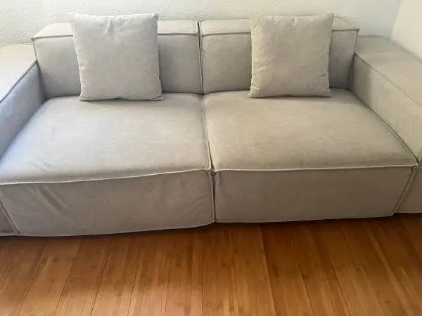 Grey Couch, including two matching pillow’s.