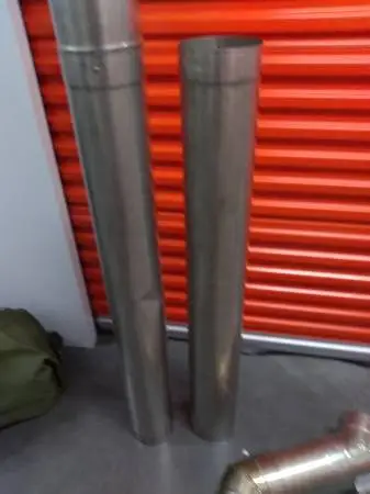 ^ stainless steel chimney liner and elbow for fireplace insert
