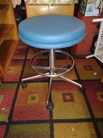 Chrome and vinyl stools on wheels