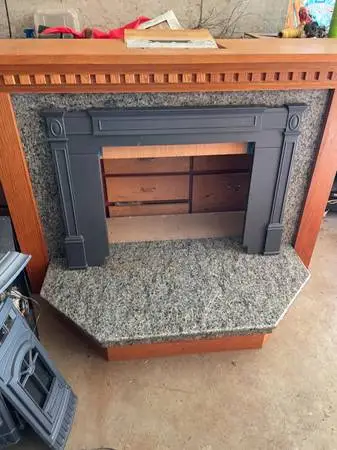 Quadrafire pellet stove insert with a Beautiful wood and granite hearth