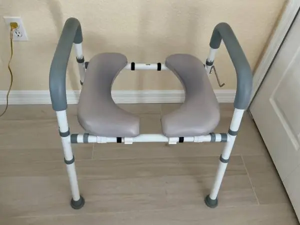 Raised seat for toilet with bars