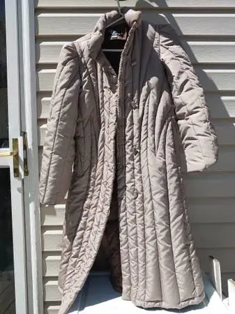 Parka-style long coat with dense down-and-feather insulation winter