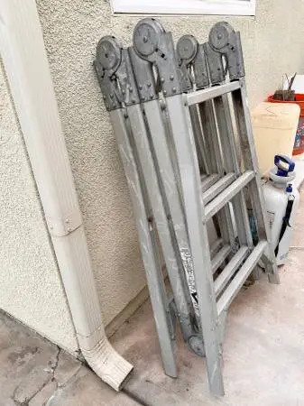 Multi - position telescoping aluminum folding ladder.