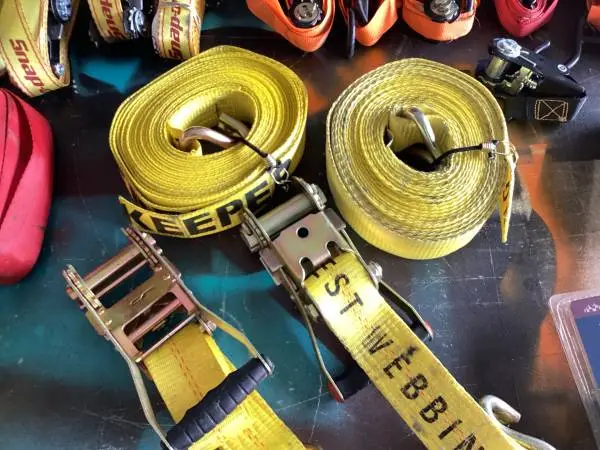 Box full of ratchet straps and few chains