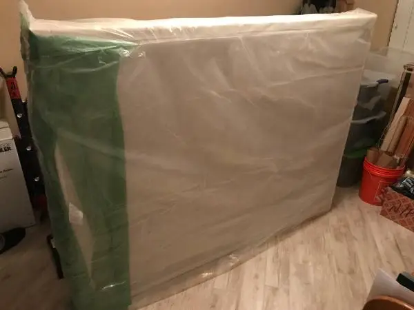 Queen size box spring and bed frame with casters.