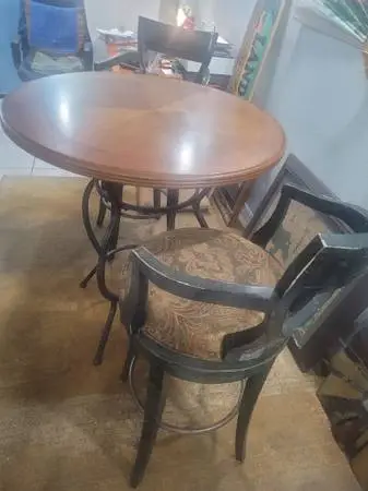 Beautiful round high-top bistro table with two chairs.