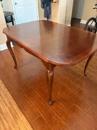 Dining table with protective cover and extra leaf