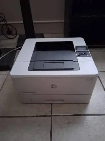 HP Laser Jet Pro M402n Printer with box of fresh ink cartridges