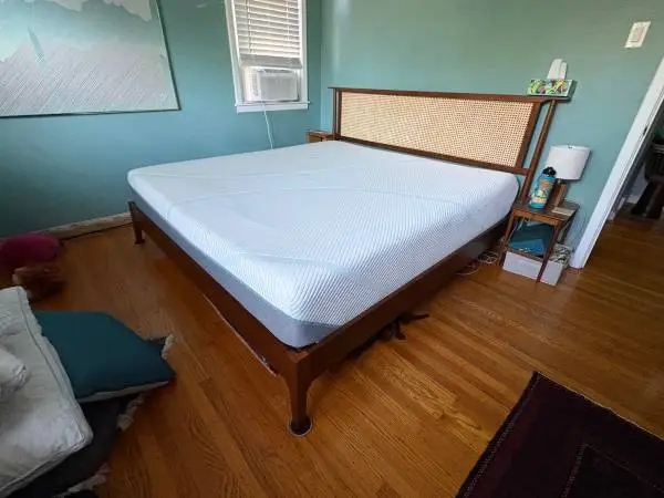 King Temperpedic mattress with mid-century style walnut frame