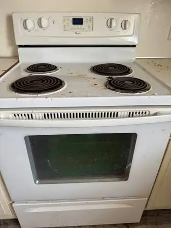Two electric stoves and two refrigerators