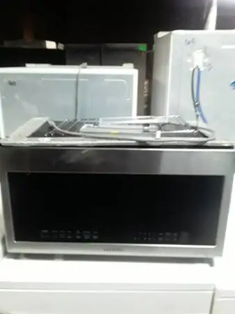 Scratch-n-dent Samsung stainless steel over the range microwave.